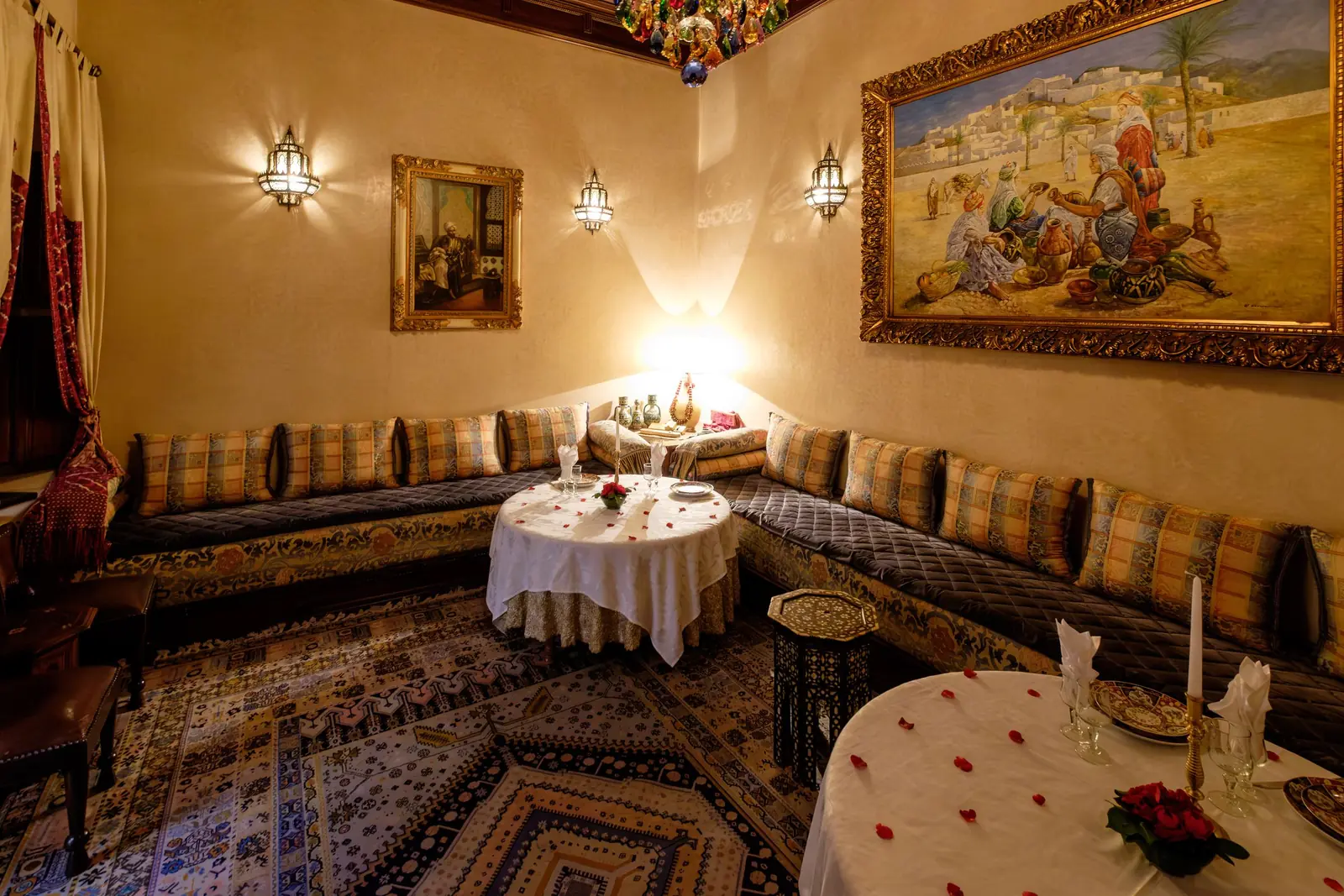 Traditional Moroccan dining room with low banquettes and a painted ceiling