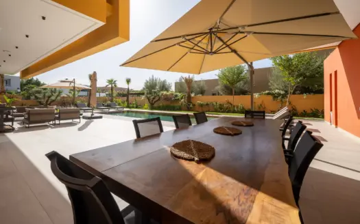 Shaded dining terrace beside the pool at Villa Venus
