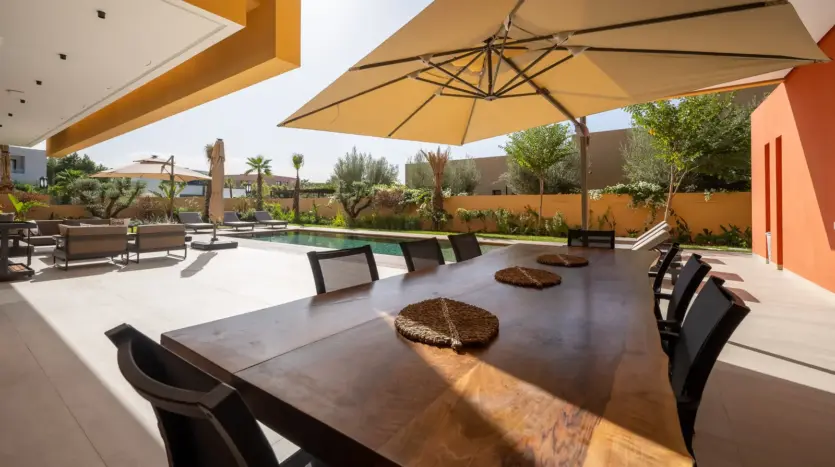 Shaded dining terrace beside the pool at Villa Venus
