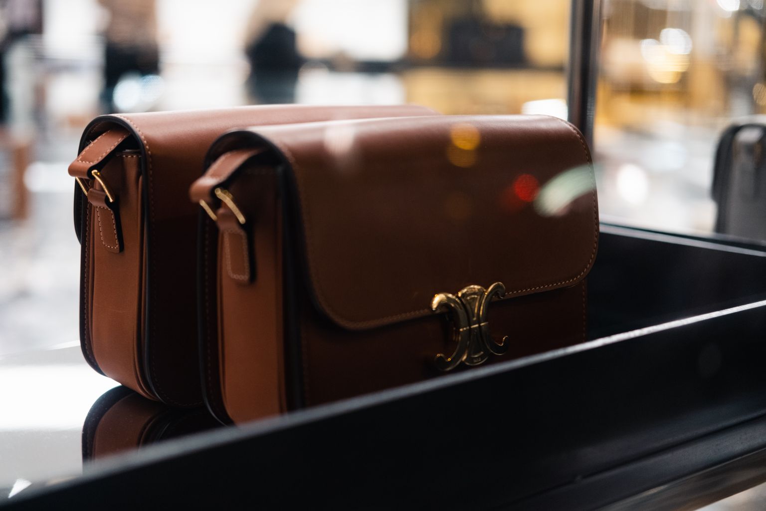 Fine tan leather handbag displayed in the lit window of a luxury boutique in Marrakech