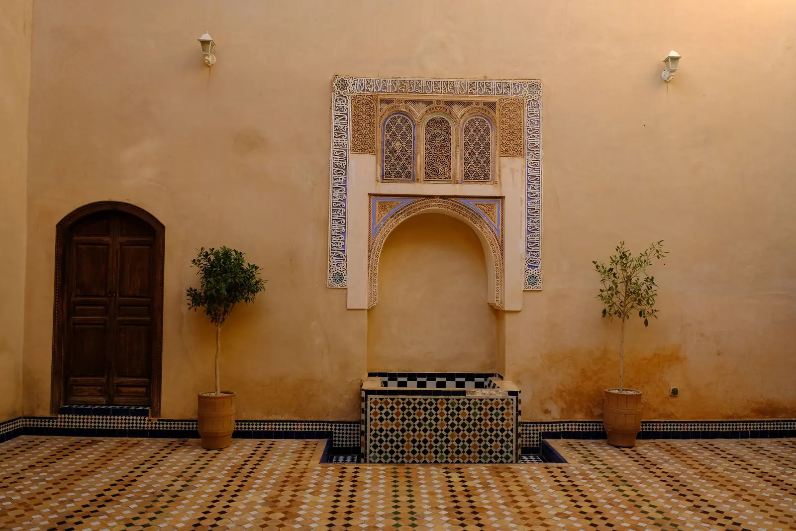 Carved plaster niche and wooden door in an old Moroccan house