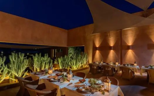 Dinner table set on the terrace of Olive Palace at night