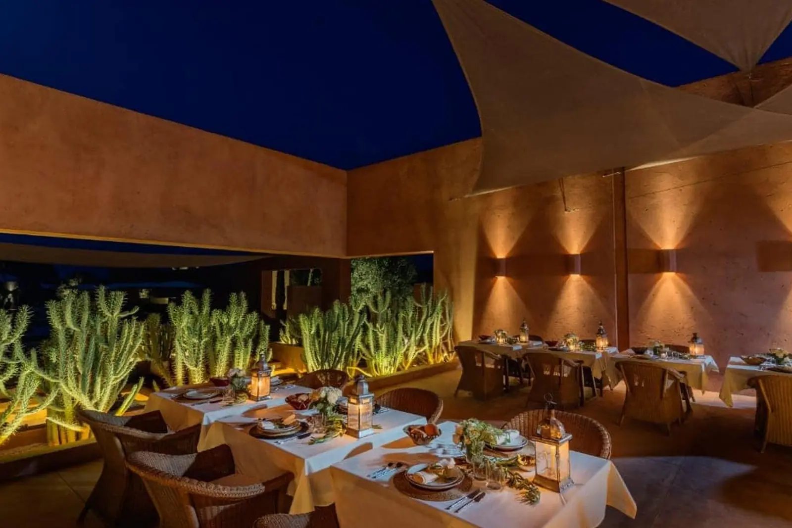 Dinner table set on the terrace of Olive Palace at night