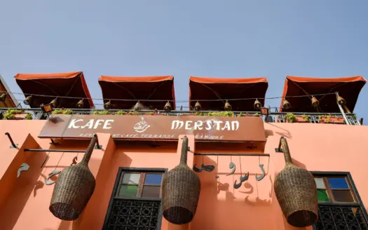Awnings and hanging baskets on the facade of Kafe Merstan in the Marrakech medina