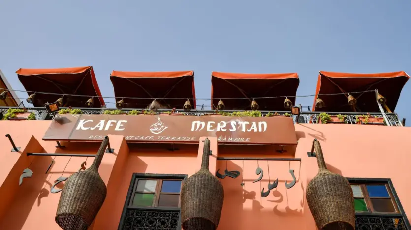 Awnings and hanging baskets on the facade of Kafe Merstan in the Marrakech medina