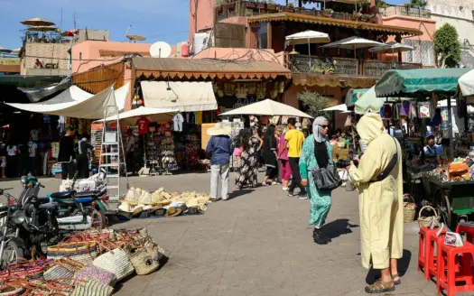 Busy market square in the medina, with stalls and shoppers