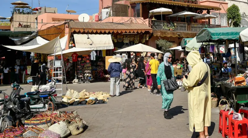 Busy market square in the medina, with stalls and shoppers