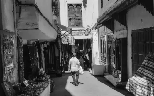 Man walking through a covered souk alley