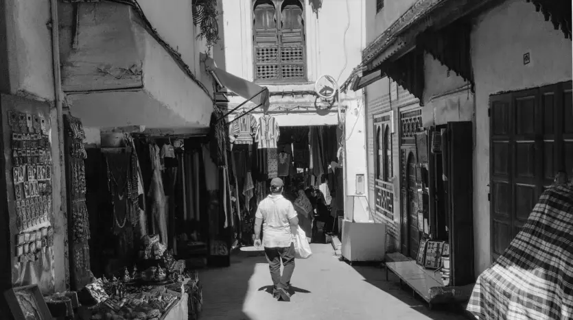 Man walking through a covered souk alley