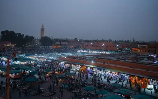 Jemaa el-Fna at dusk, with the Koutoubia minaret in the distance