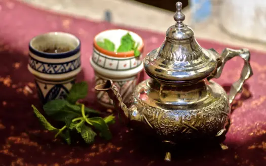 Moroccan silver teapot and tea glasses with fresh mint