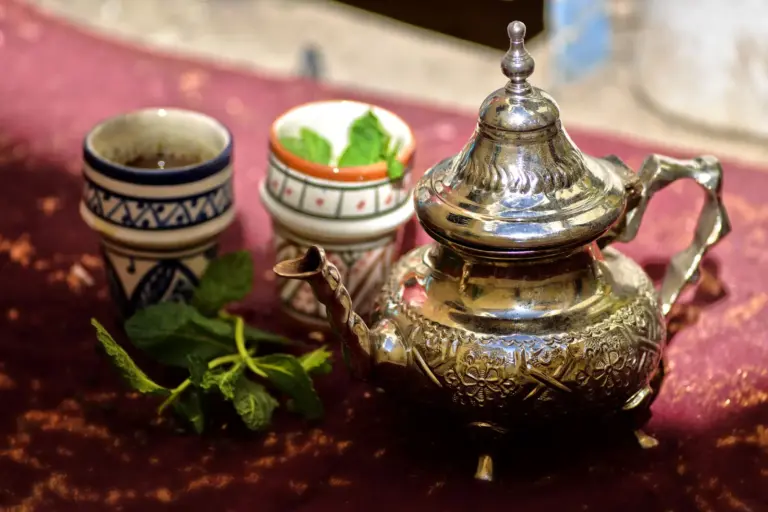 Moroccan silver teapot and tea glasses with fresh mint