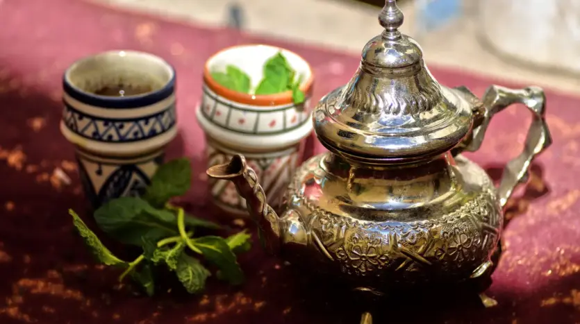 Moroccan silver teapot and tea glasses with fresh mint