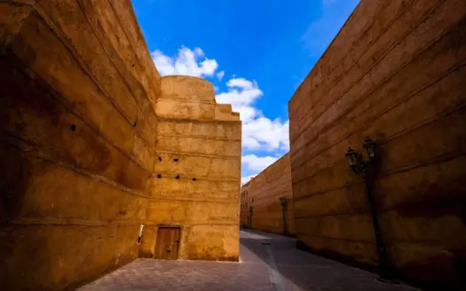 Ochre walls under a clear blue sky