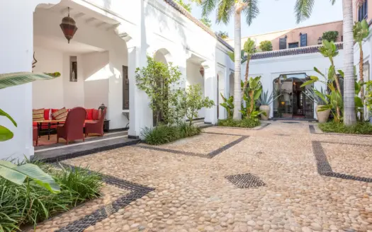 Courtyard of Villa Edith with plants and arcades