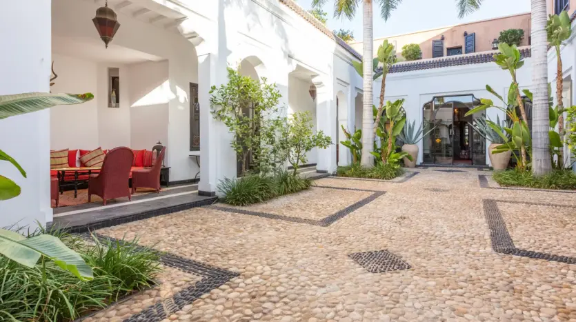 Courtyard of Villa Edith with plants and arcades