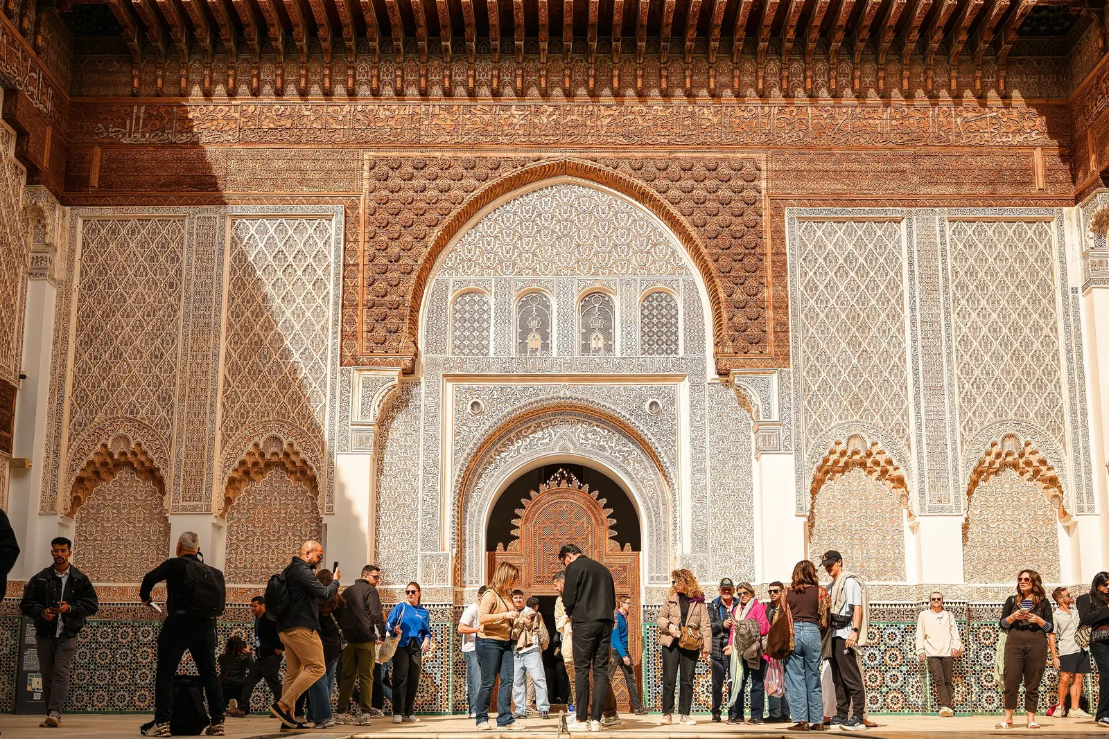 Visitors in the courtyard of the Ben Youssef Madrasa