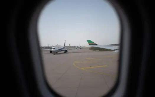 Aircraft on the apron seen through a cabin window