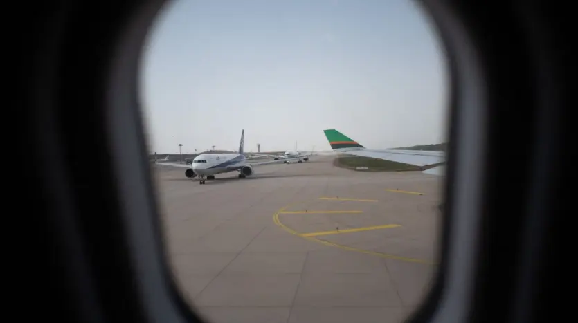 Aircraft on the apron seen through a cabin window
