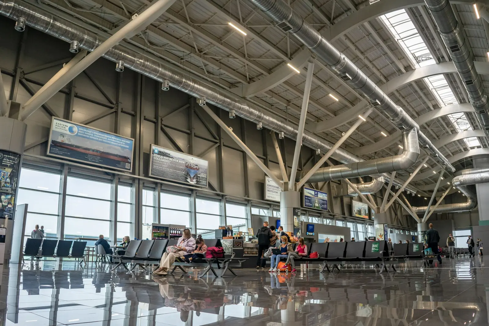 Passengers in a bright airport terminal