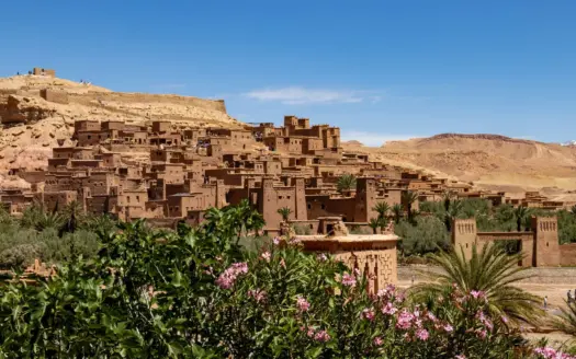 The fortified ksar of Ait Ben Haddou behind oleanders and palms