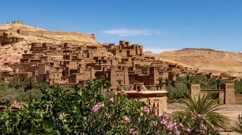 The fortified ksar of Ait Ben Haddou behind oleanders and palms