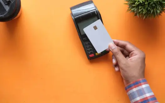 Bank card being tapped on a contactless payment terminal