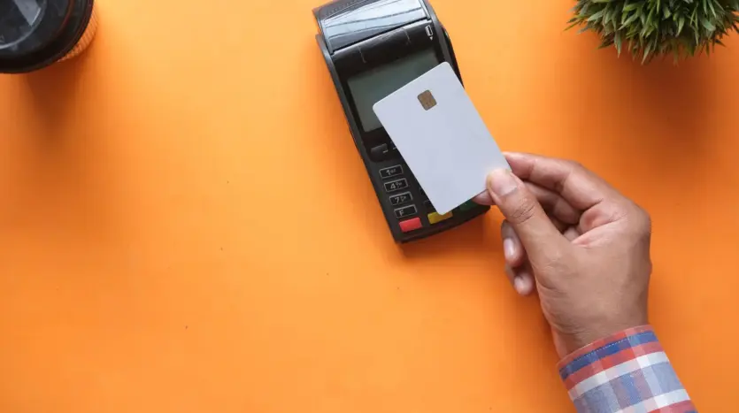 Bank card being tapped on a contactless payment terminal