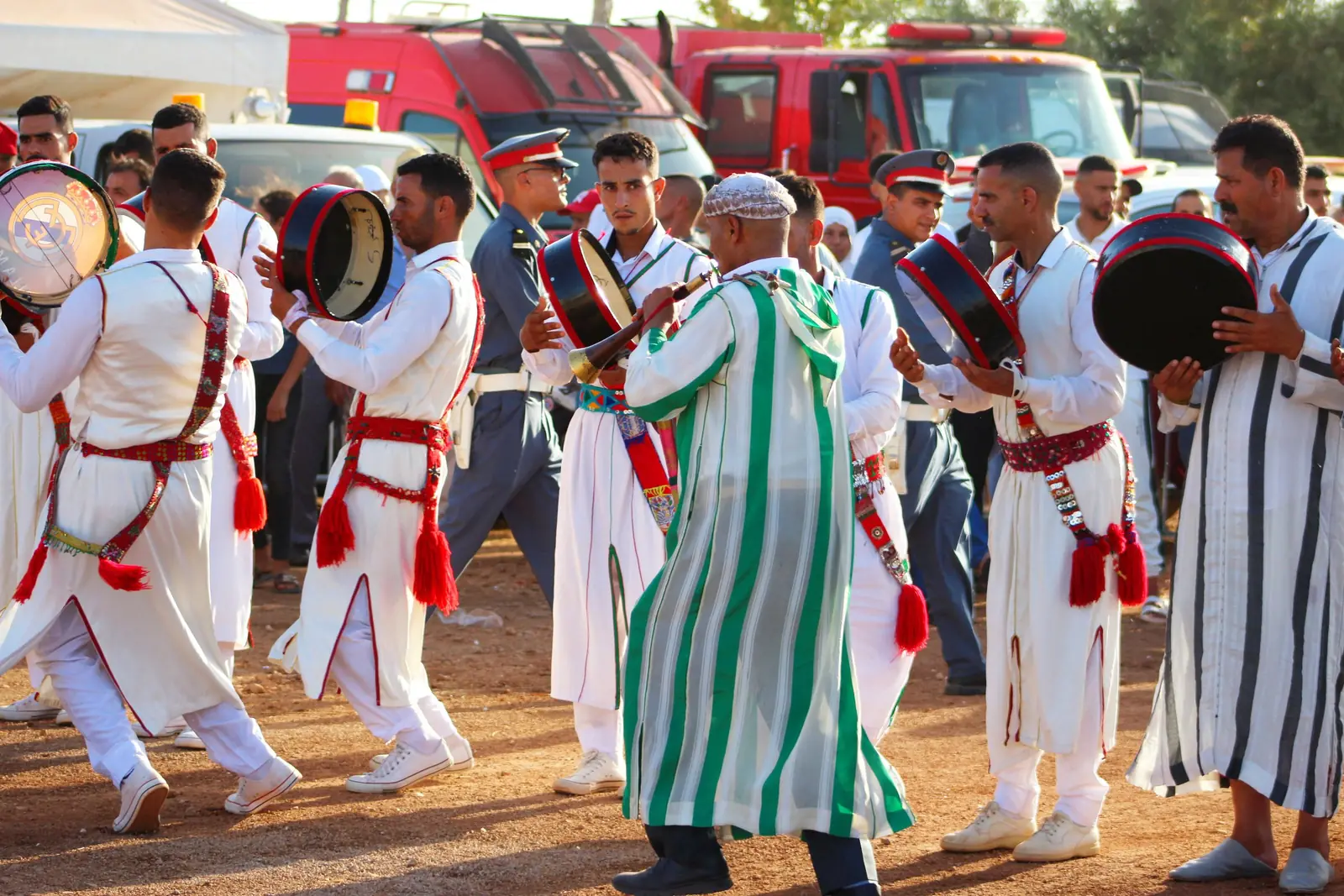 Musicians in traditional dress drumming at a Moroccan festival