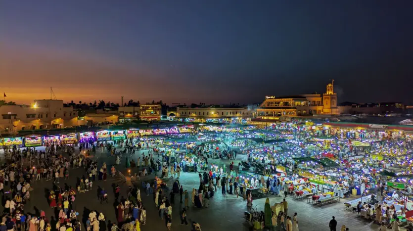 Jemaa el-Fna square filled with food stalls and crowds at dusk
