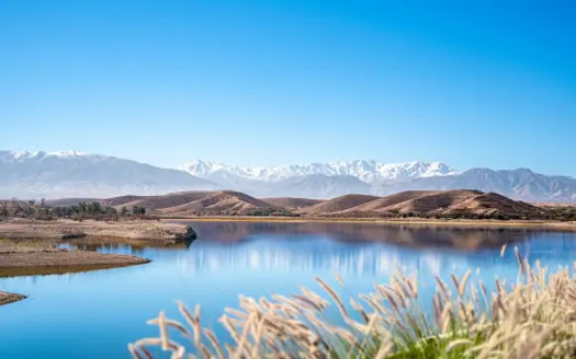 Reservoir lake with the snow-capped High Atlas on the horizon