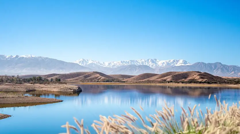 Reservoir lake with the snow-capped High Atlas on the horizon