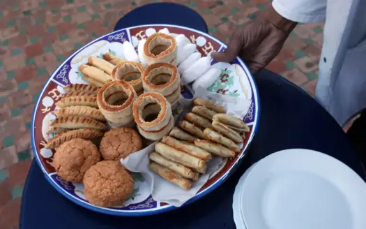 Platter of traditional Moroccan pastries and biscuits on a painted ceramic plate