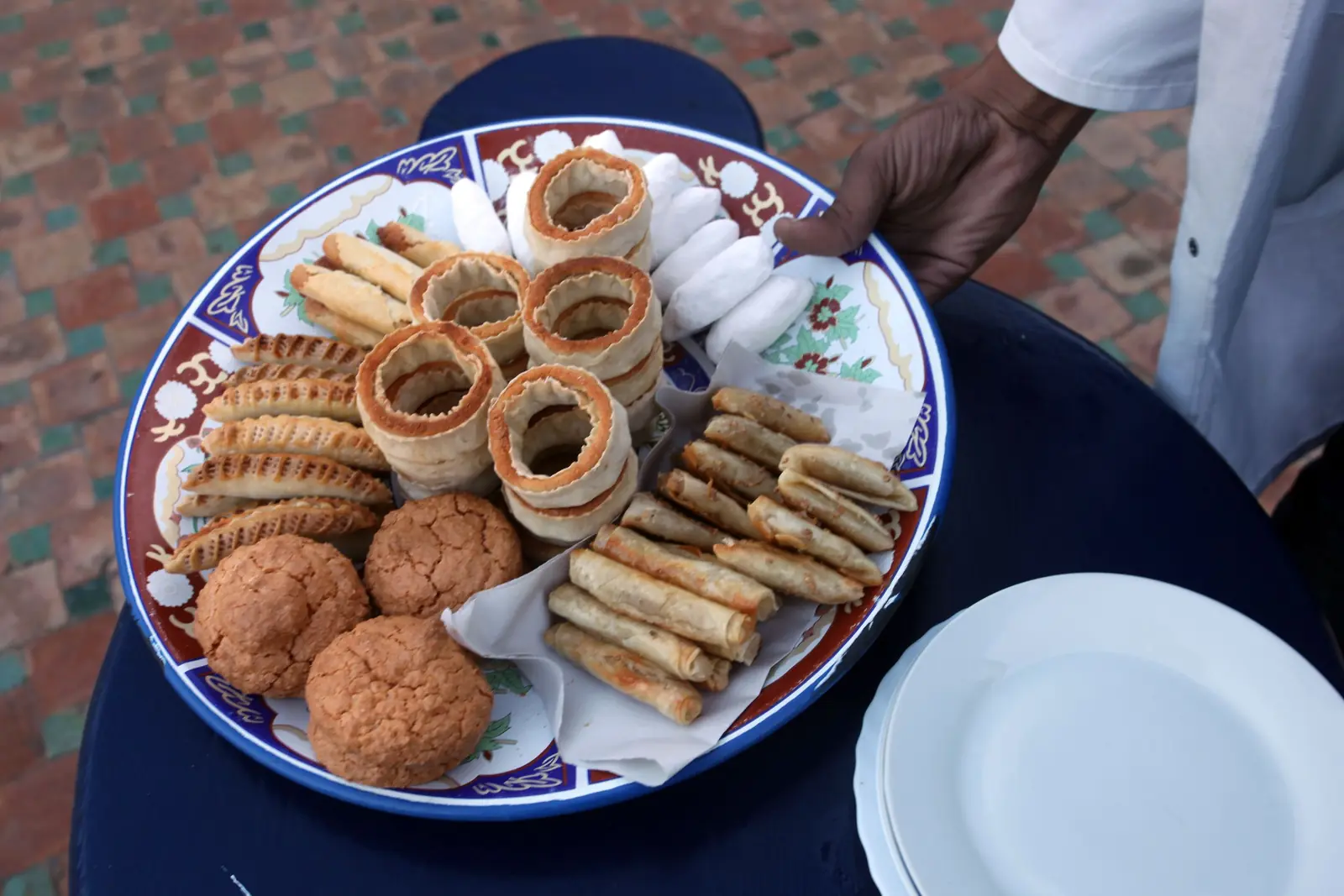 Platter of traditional Moroccan pastries and biscuits on a painted ceramic plate