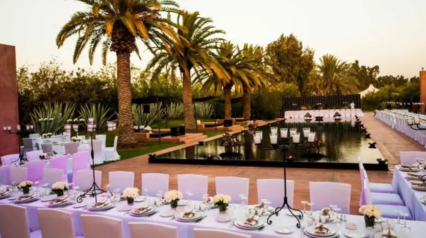 Long banquet table set beside the pool at Olive Palace at dusk
