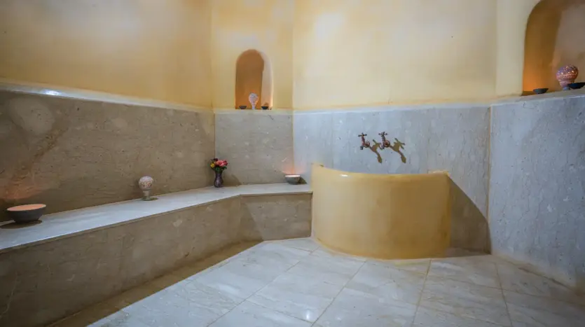 Private hammam with a heated stone bench at Palais Mauresque, a villa in Marrakech