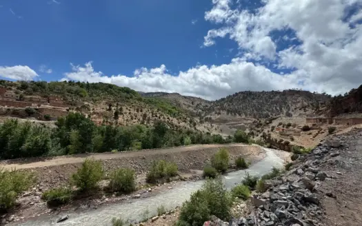 River running through a green valley in the Atlas Mountains