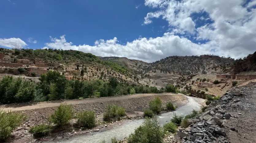River running through a green valley in the Atlas Mountains