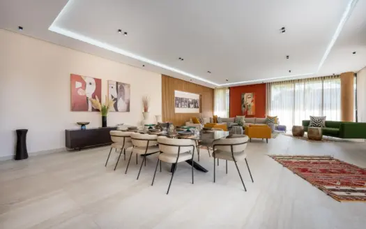 Long dining table in the open-plan living room of Villa Venus
